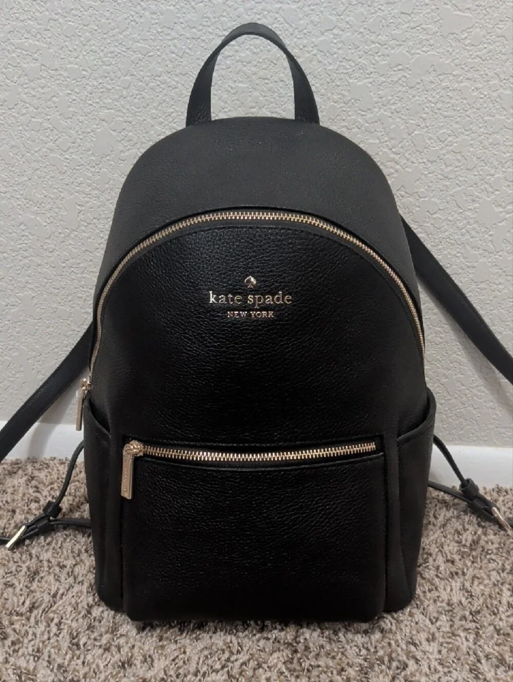 Kate Spade Leila black pebbled leather medium dome backpack with gold hardware